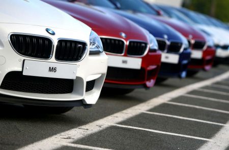 Poland: Driver collides with a BMW at a vehicle dealership.