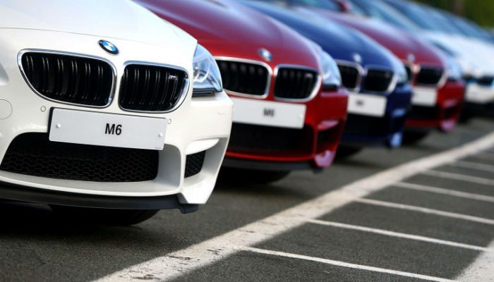 Poland: Driver collides with a BMW at a vehicle dealership.